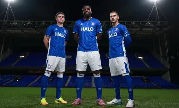 Three players posing in blue team jerseys