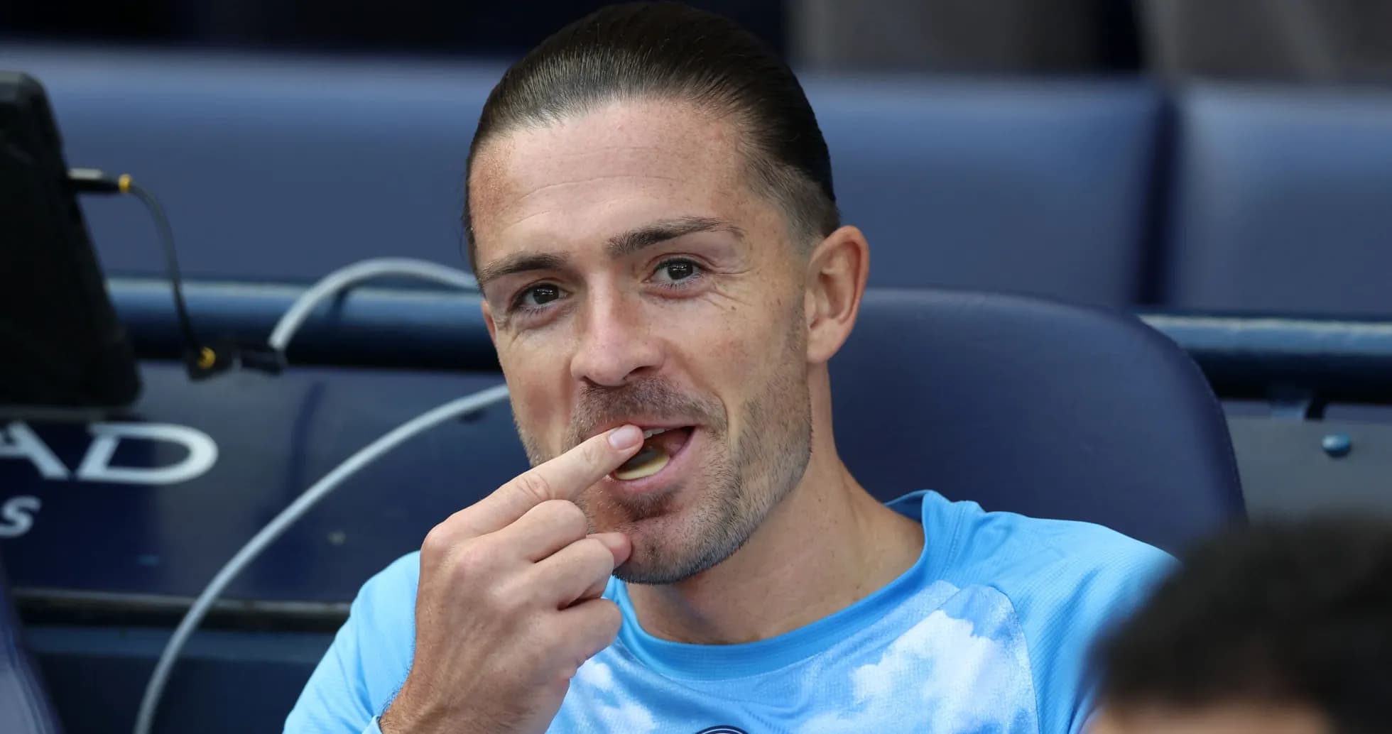 Player eating snack on bench during match