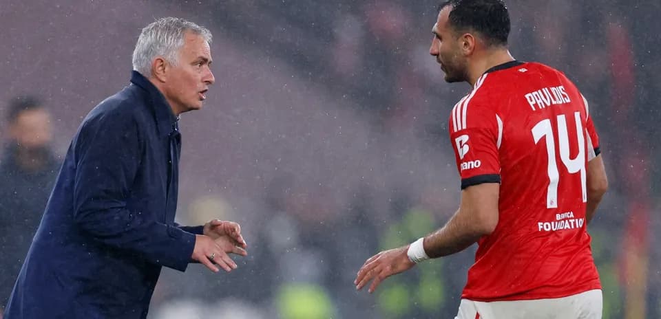 Manager instructing player during rainy match