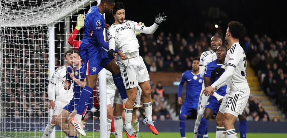 Chelsea player attempting to score against Fulham