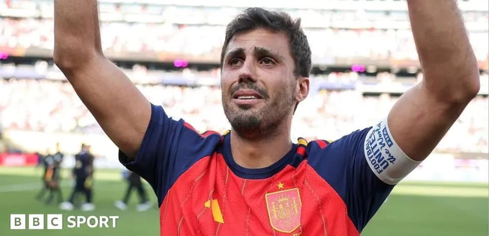 Player celebrating with raised arms in Spain jersey