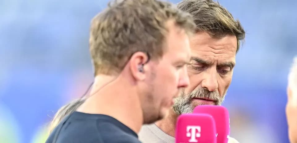 Two men speaking into microphones during broadcast