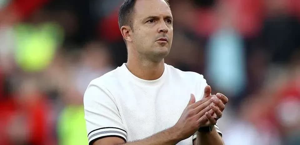 Coach clapping during a match in stadium