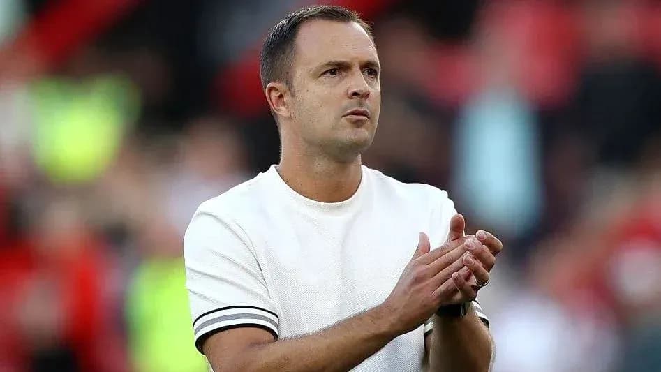 Coach clapping during a match in stadium