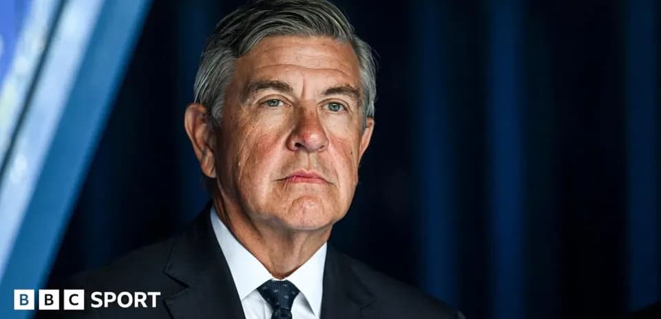 Man in suit at a press conference setting