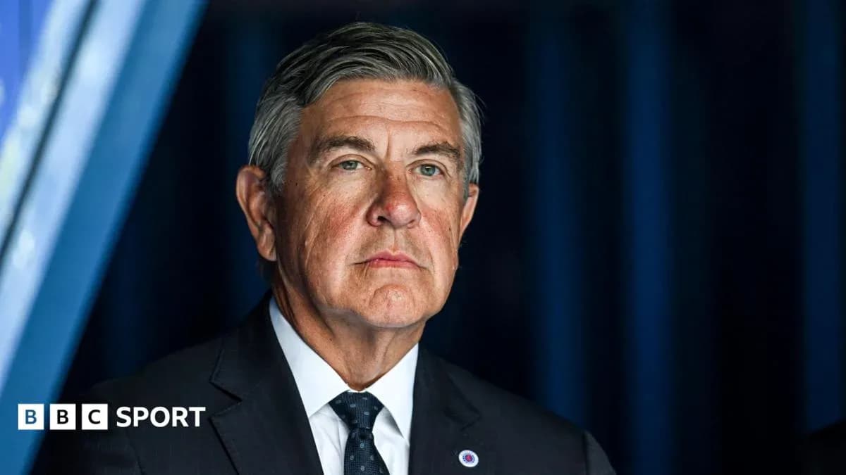 Man in suit at a press conference setting
