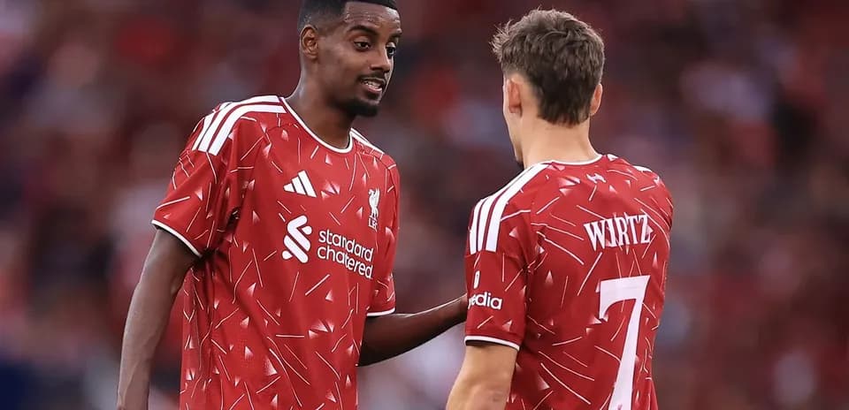 Two Liverpool players discussing on the field