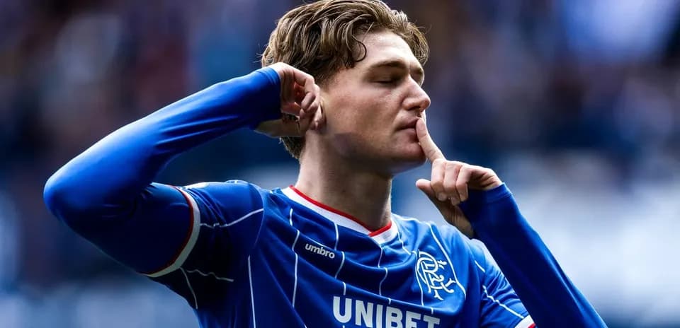 Player celebrating with finger on lips during match