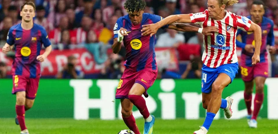 Barcelona player dribbling past Atletico Madrid defender