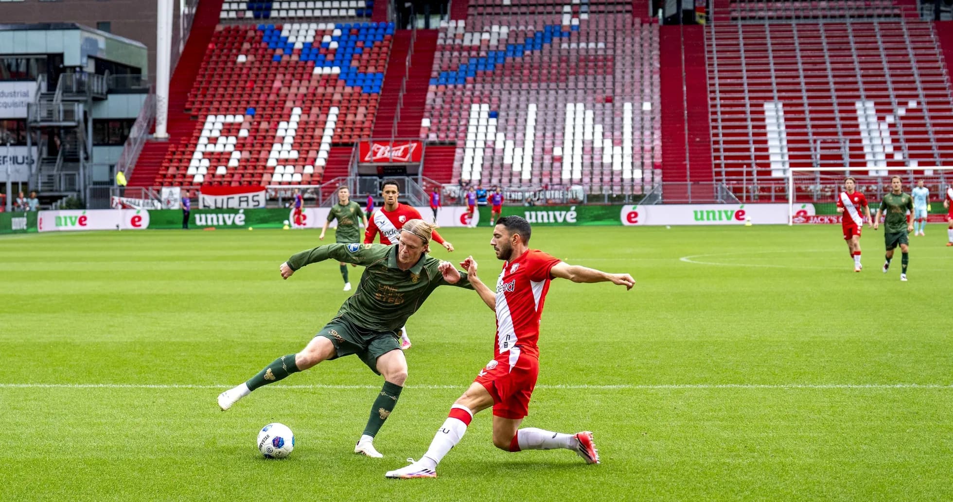 Player tackling opponent during football match on field