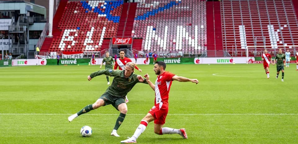 Player tackling opponent during football match on field