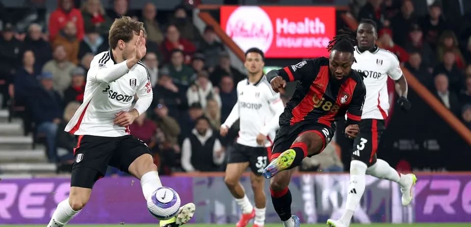 Fulham player challenges Bournemouth opponent during match