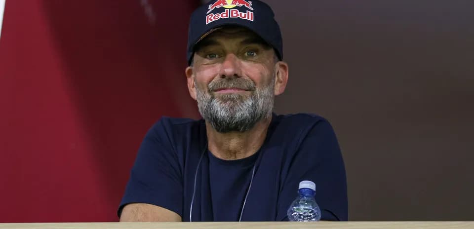 Man with a beard wearing a Red Bull cap