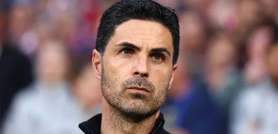 Coach observing during a match with focused expression