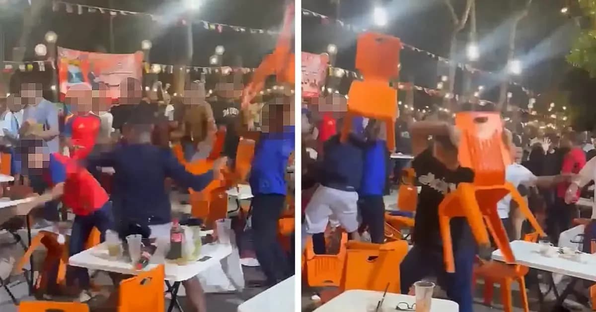 Crowd throwing chairs during an event at night