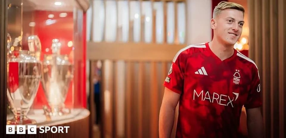 Player in Nottingham Forest jersey near trophies display