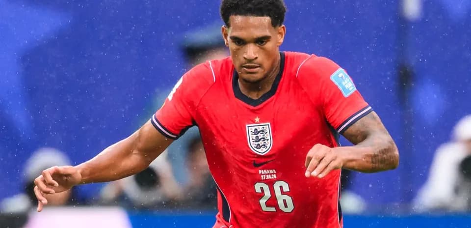Player in red England jersey running on the field