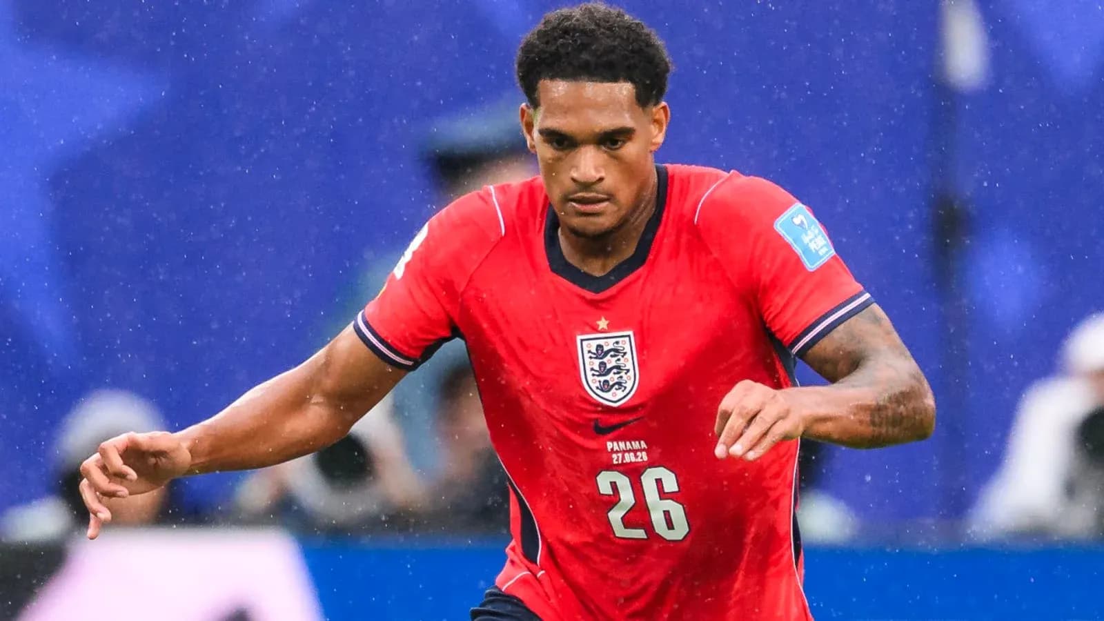 Player in red England jersey running on the field