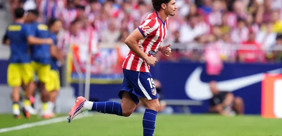 Player wearing Atlético Madrid kit running on field