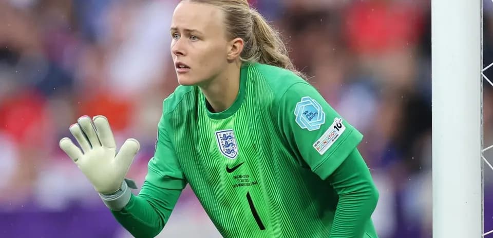 Goalkeeper in green uniform preparing for play