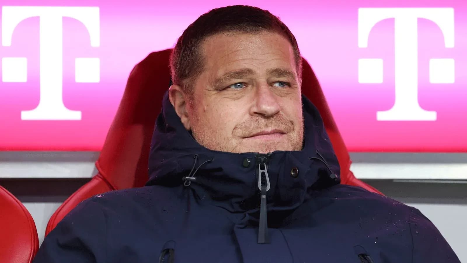 Coach sitting on the bench during match