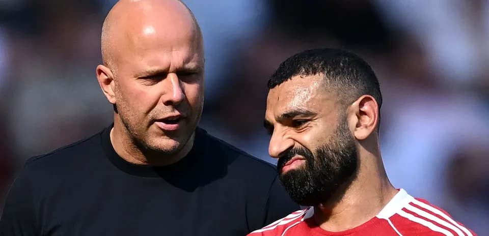 Two men talking on the field during warm-up
