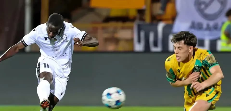 Ararat-Armenia player striking the ball during match