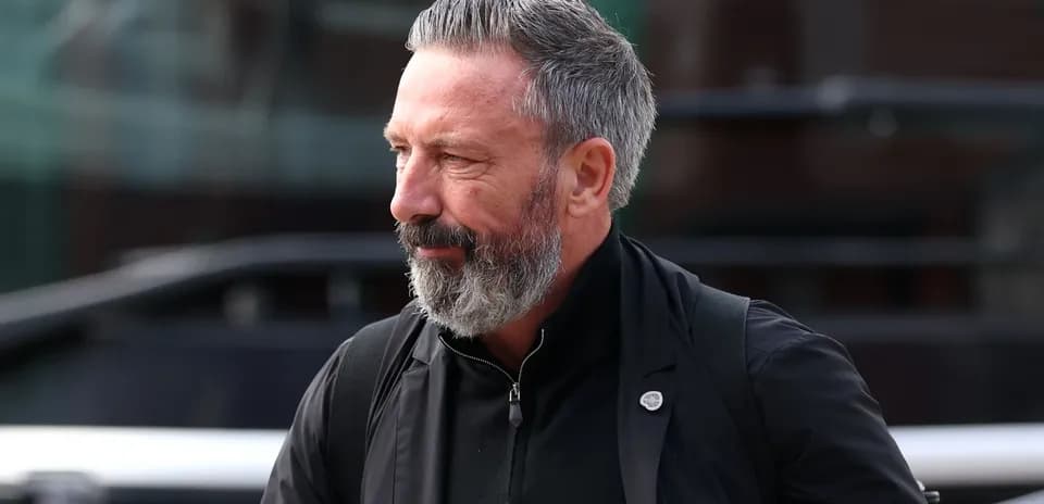 Man with gray beard walking outside venue