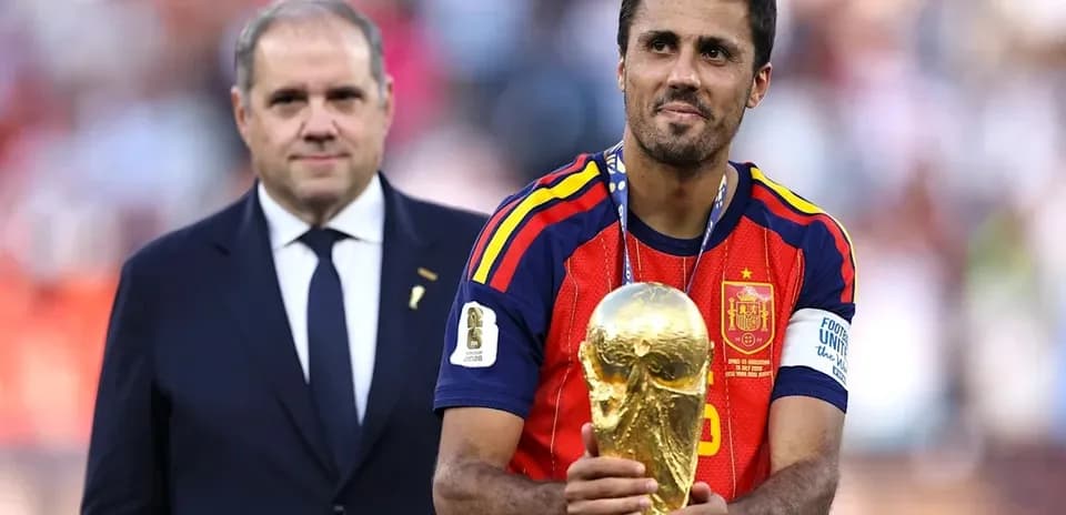 Player holding World Cup trophy with official nearby