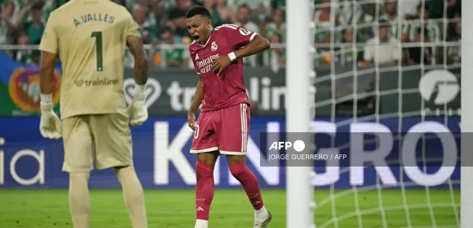 Player celebrating a goal with goalkeeper in background