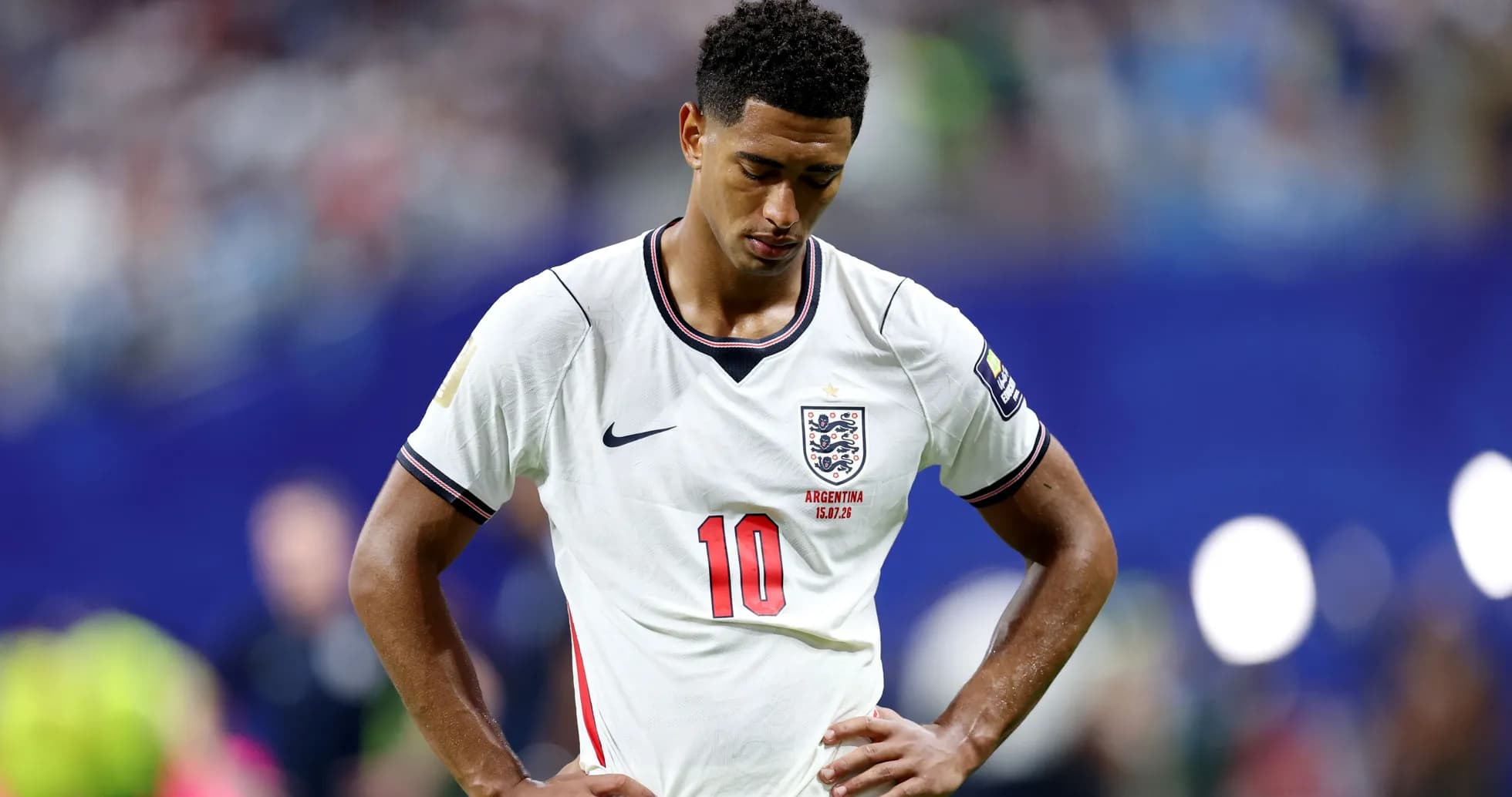 Player in England jersey looking down on the field