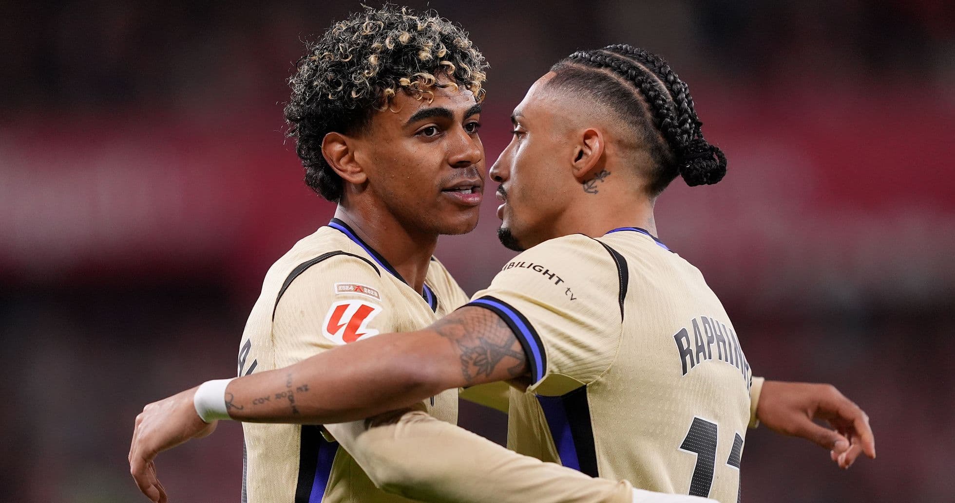 Two players celebrating a goal on the field