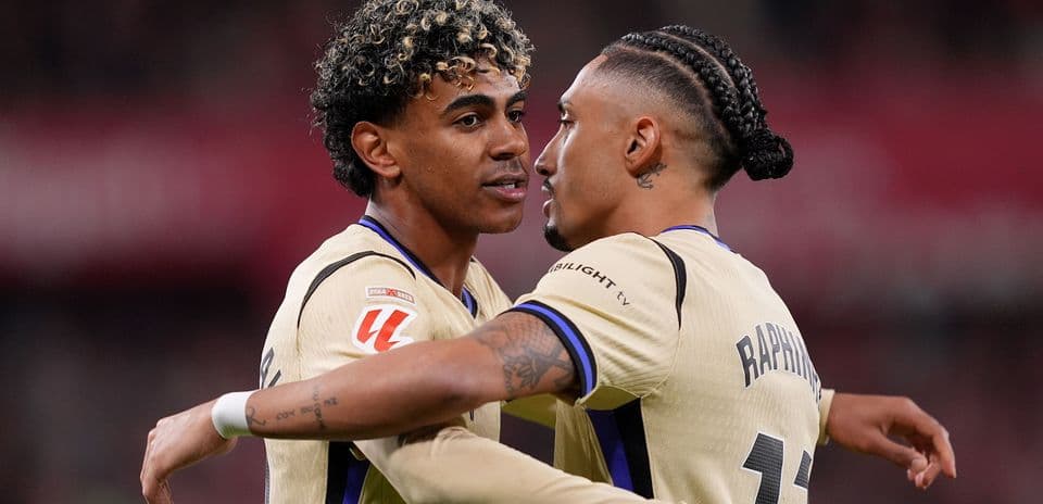 Two players celebrating a goal on the field