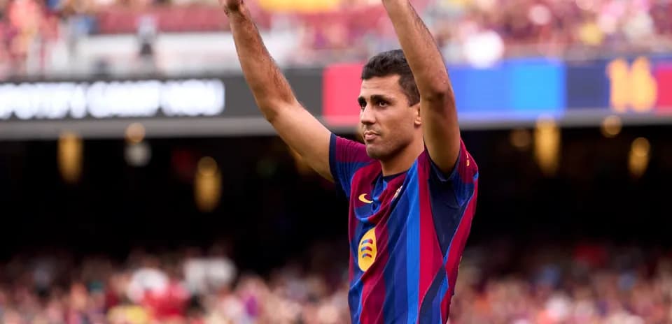 Player raising hands in celebration at Camp Nou