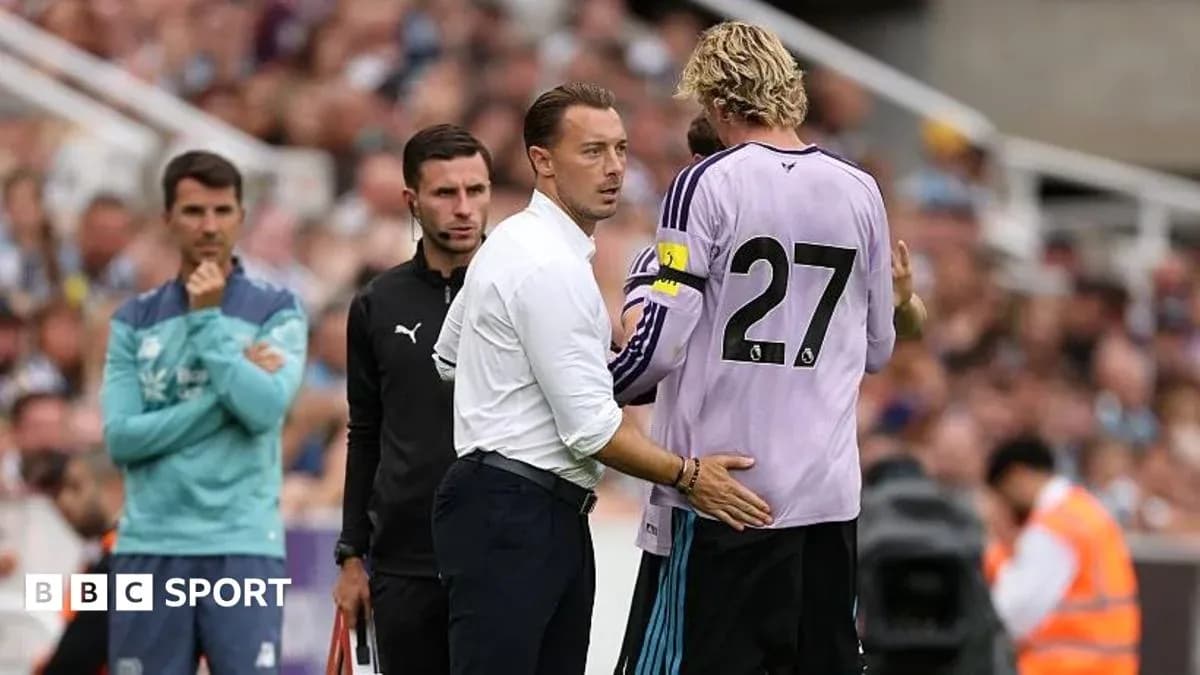 Coach talking to goalkeeper during match substitution
