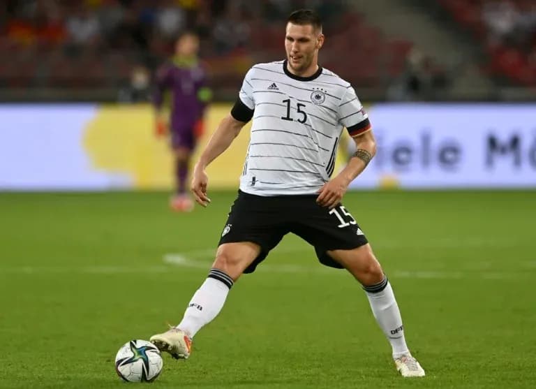 Player in Germany kit controlling the ball during match