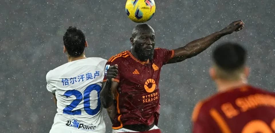 Players contesting a header during AS Roma match