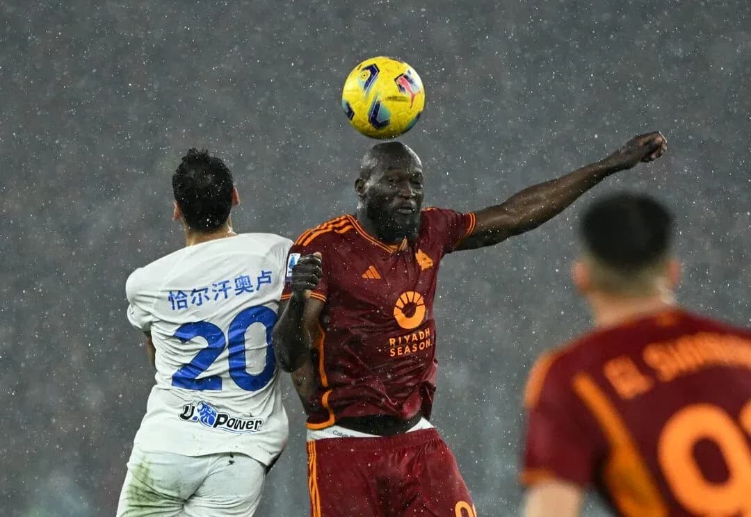 Players contesting a header during AS Roma match