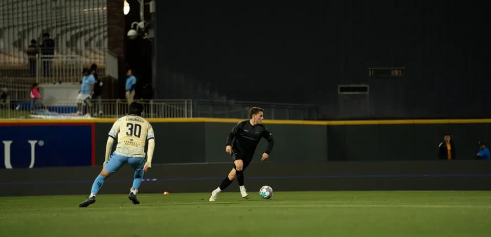 Player dribbling ball during Colorado Springs match