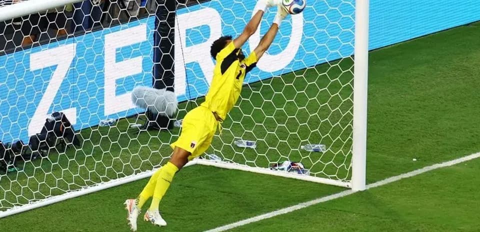 Goalkeeper diving to make a save during match