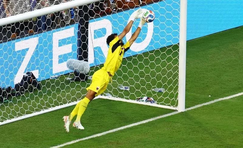 Goalkeeper diving to make a save during match