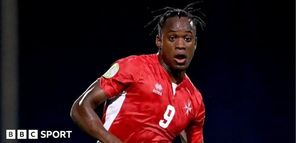 Player in red jersey running during football match