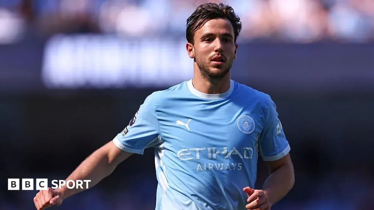 Player in light blue kit running on the pitch