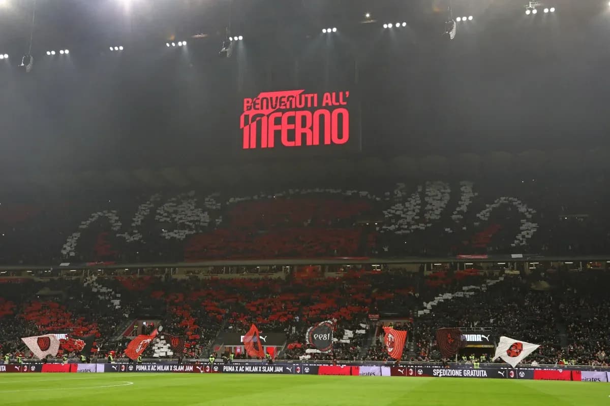 Fans displaying banners at stadium with lights on