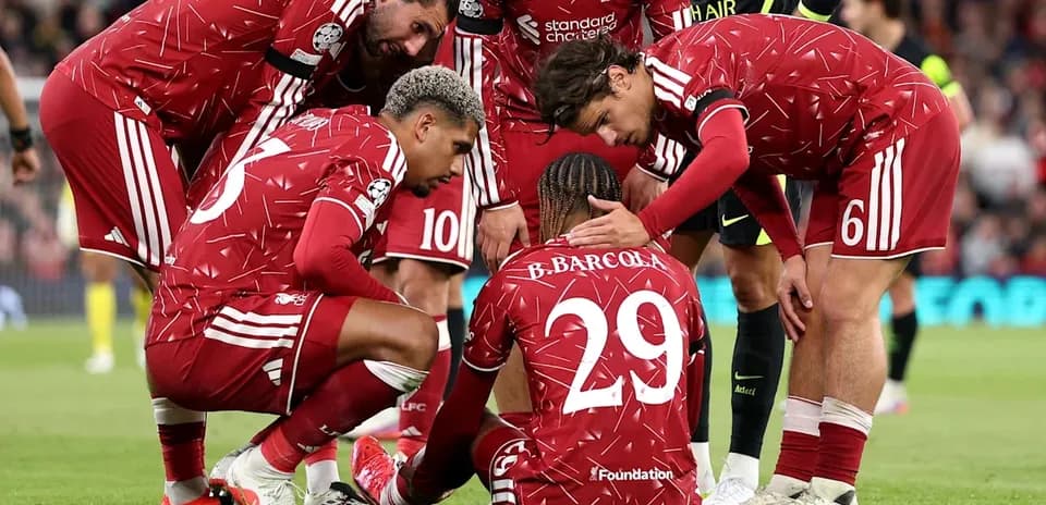 Liverpool players comforting teammate on the pitch