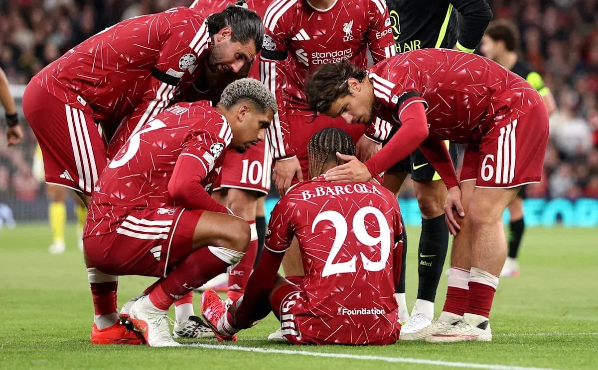 Liverpool players comforting teammate on the pitch