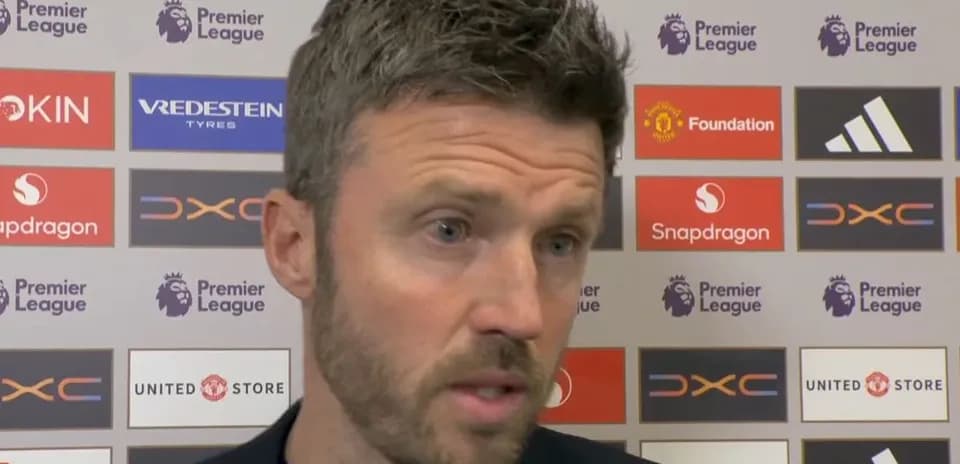 Manager speaking at press conference with logos behind