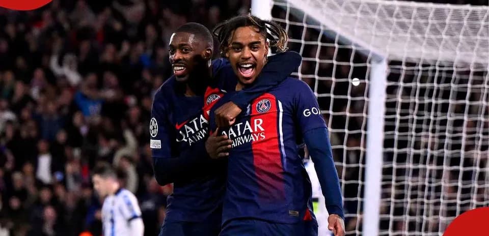 Two PSG players celebrating a goal on the field