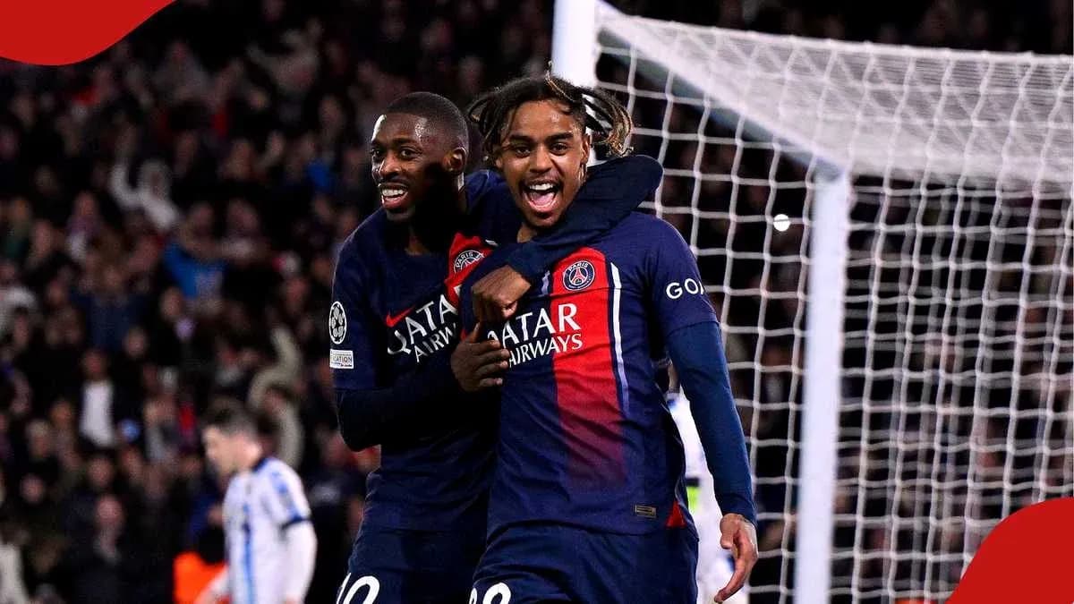 Two PSG players celebrating a goal on the field