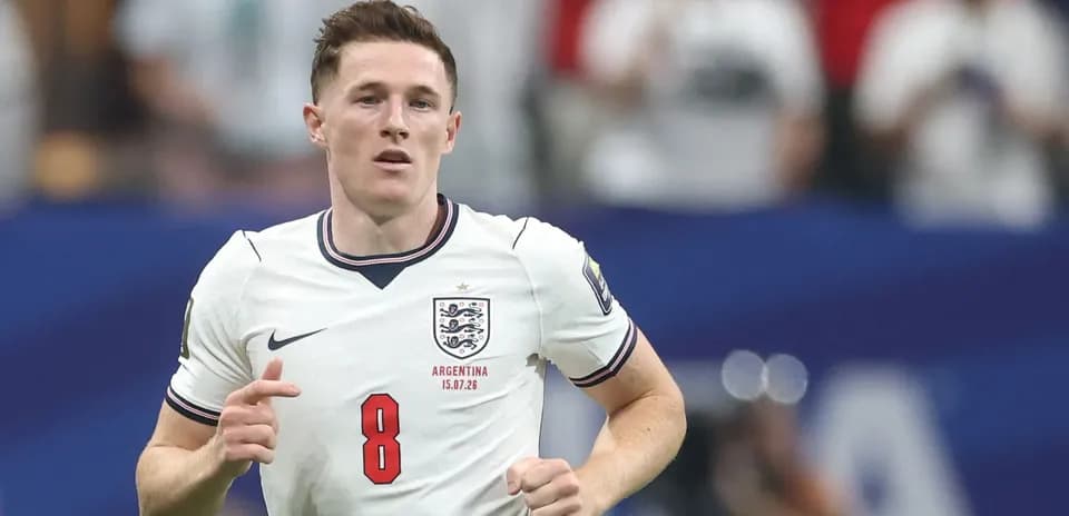 Player wearing England kit running on the pitch
